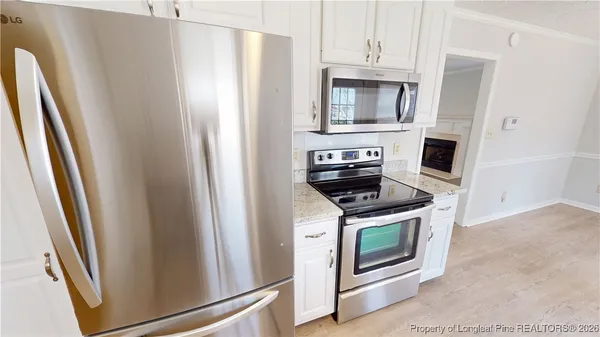 a kitchen with stainless steel appliances a stove a microwave and a refrigerator