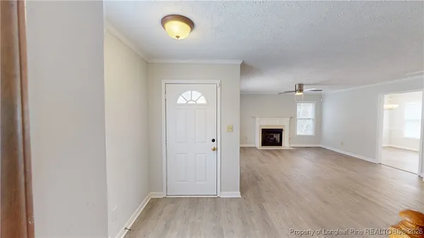 an empty room with wooden floor and a window