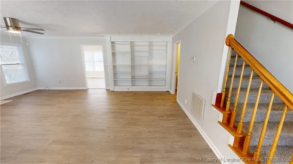 a view of an entryway with wooden floor and door