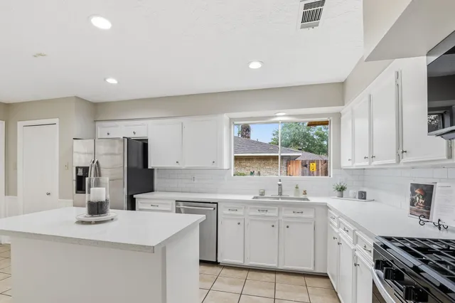 a kitchen with appliances cabinets and a sink