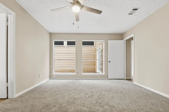 an empty room with a empty space and a ceiling fan
