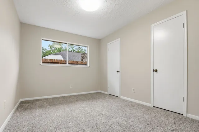 a view of room with window and hallway