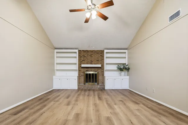 wooden floor in an empty room with a fireplace