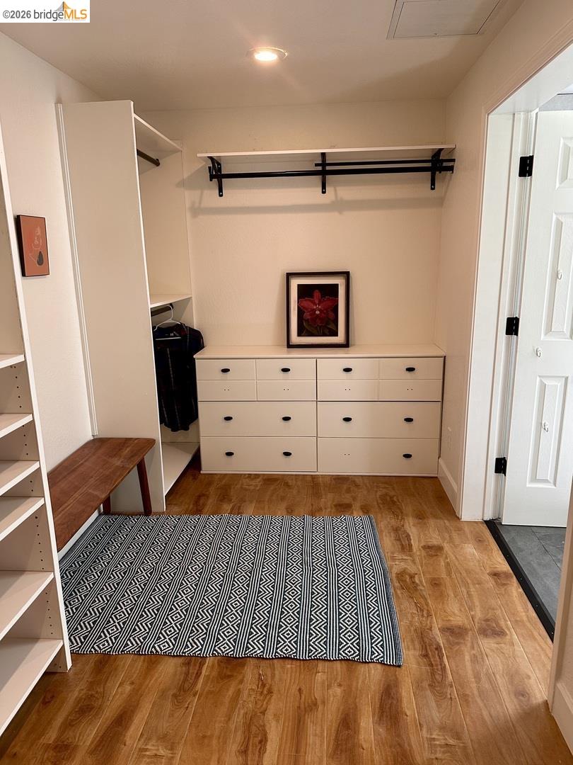 2080 Nelson Road Camino, CA 95709 - Photo 38 of 55 Wood-finish flooring, recessed lighting, built-in shelving, white cabinetry with black hardware, and a white paneled door