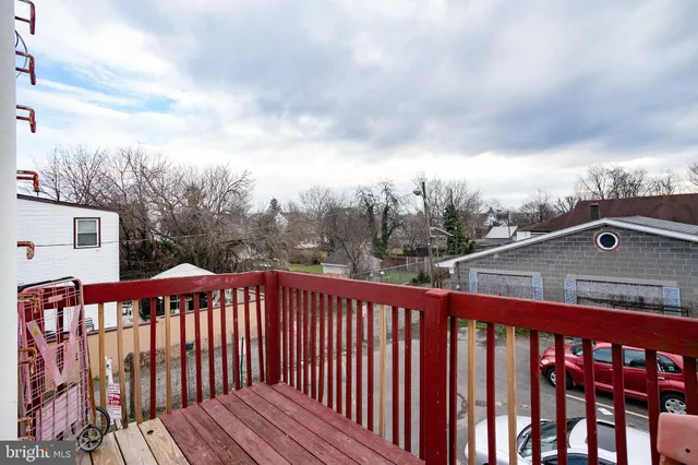 a view of a roof deck with wooden floor and fence