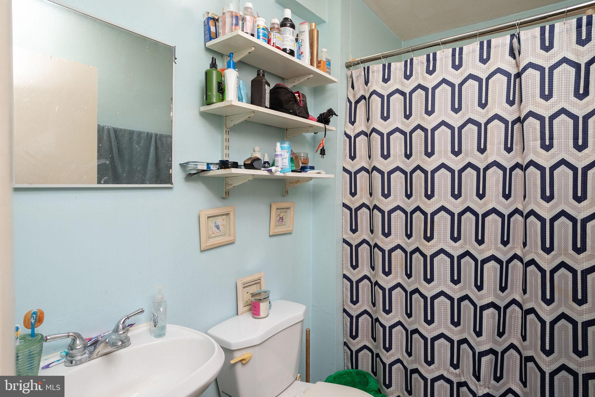 127 Kent Street Trenton, NJ 08611 - Photo 22 of 25 a bathroom with a sink toilet and shower curtain