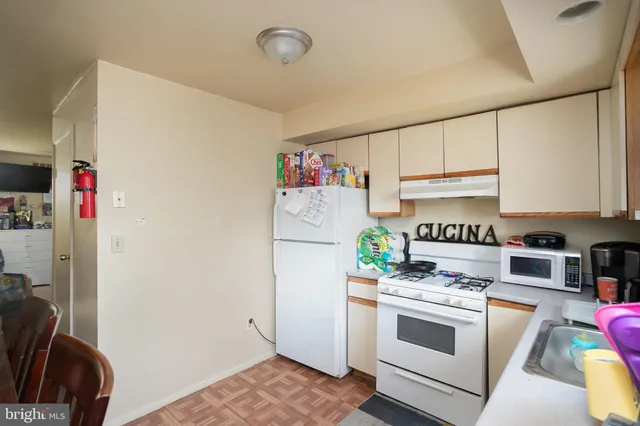 a kitchen with stainless steel appliances a stove and a refrigerator