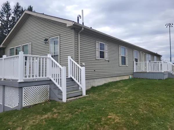 a view of a house with a yard and deck