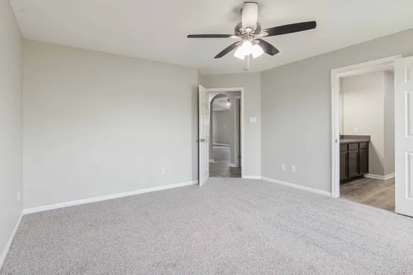 a view of a hallway with a chandelier fan