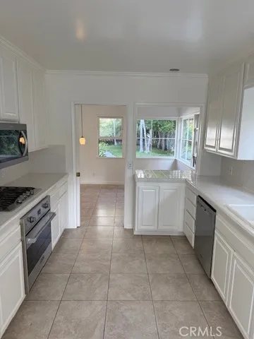 a kitchen with a stove a sink and a refrigerator