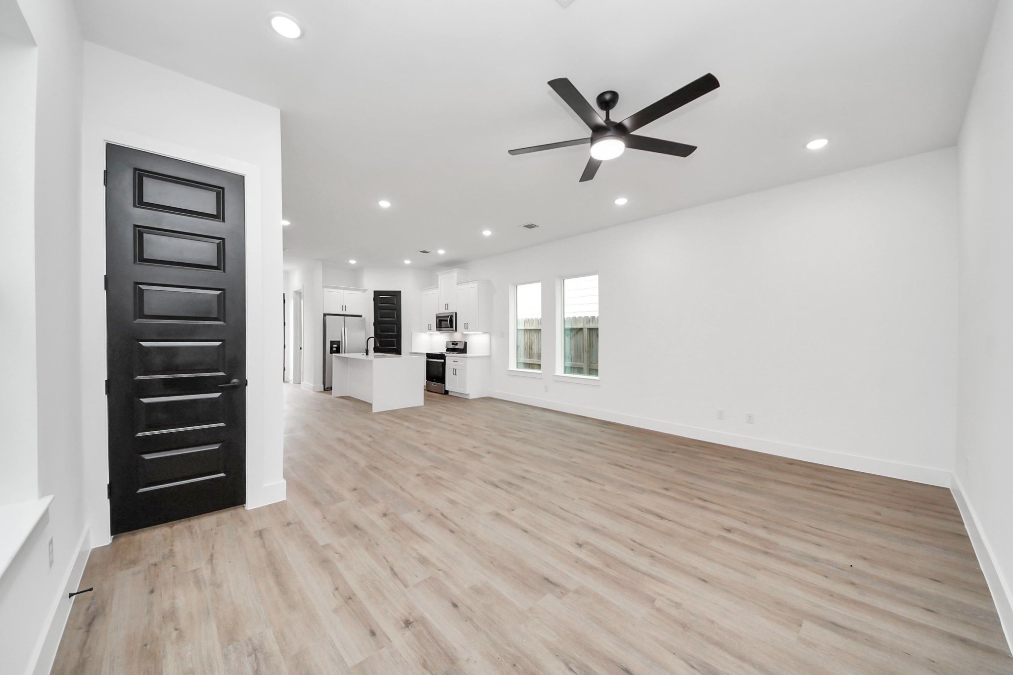 3308 Hardy Street Houston, TX 77009 - Photo 3 of 31 a view of a livingroom with a hardwood floor and a ceiling fan
