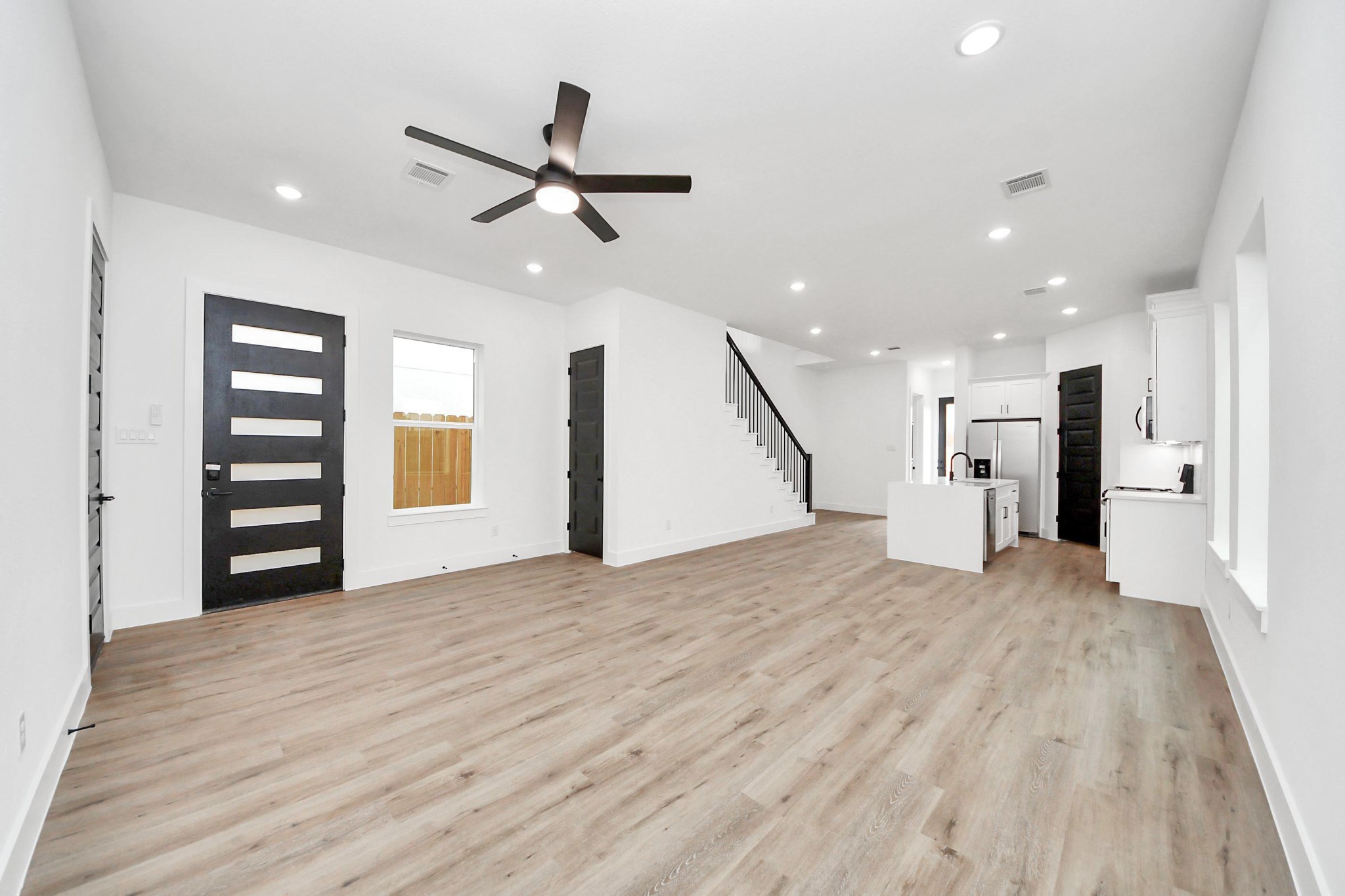 3308 Hardy Street Houston, TX 77009 - Photo 4 of 31 a view of an empty room with a window and wooden floor