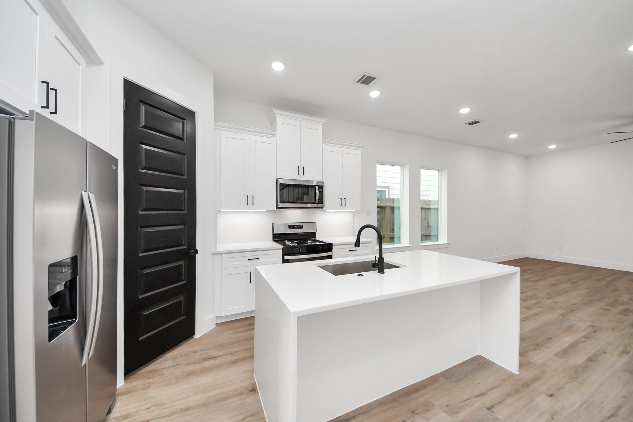 3308 Hardy Street Houston, TX 77009 - Photo 6 of 31 a kitchen with a sink stainless steel appliances and counter space