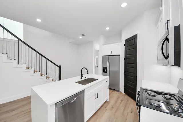 a kitchen with a sink stove and refrigerator