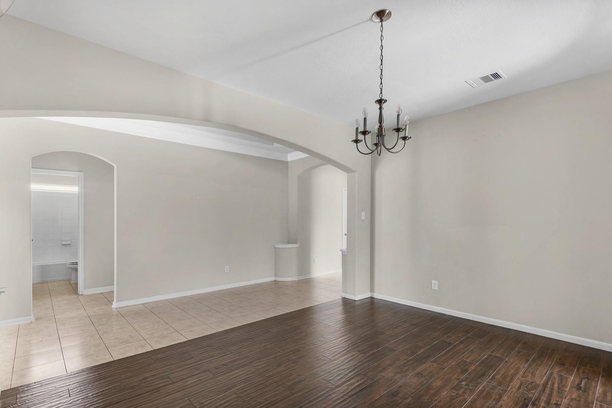 8514 Sweetstone Field Court Cypress, TX 77433 - Photo 12 of 23 a view of a room with wooden floor and a ceiling fan