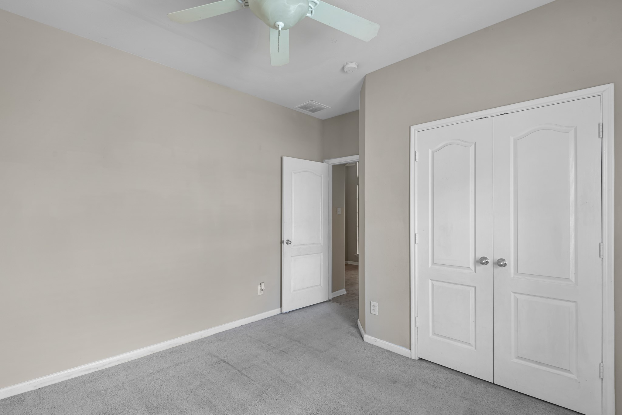 8514 Sweetstone Field Court Cypress, TX 77433 - Photo 16 of 23 an empty room with a ceiling fan