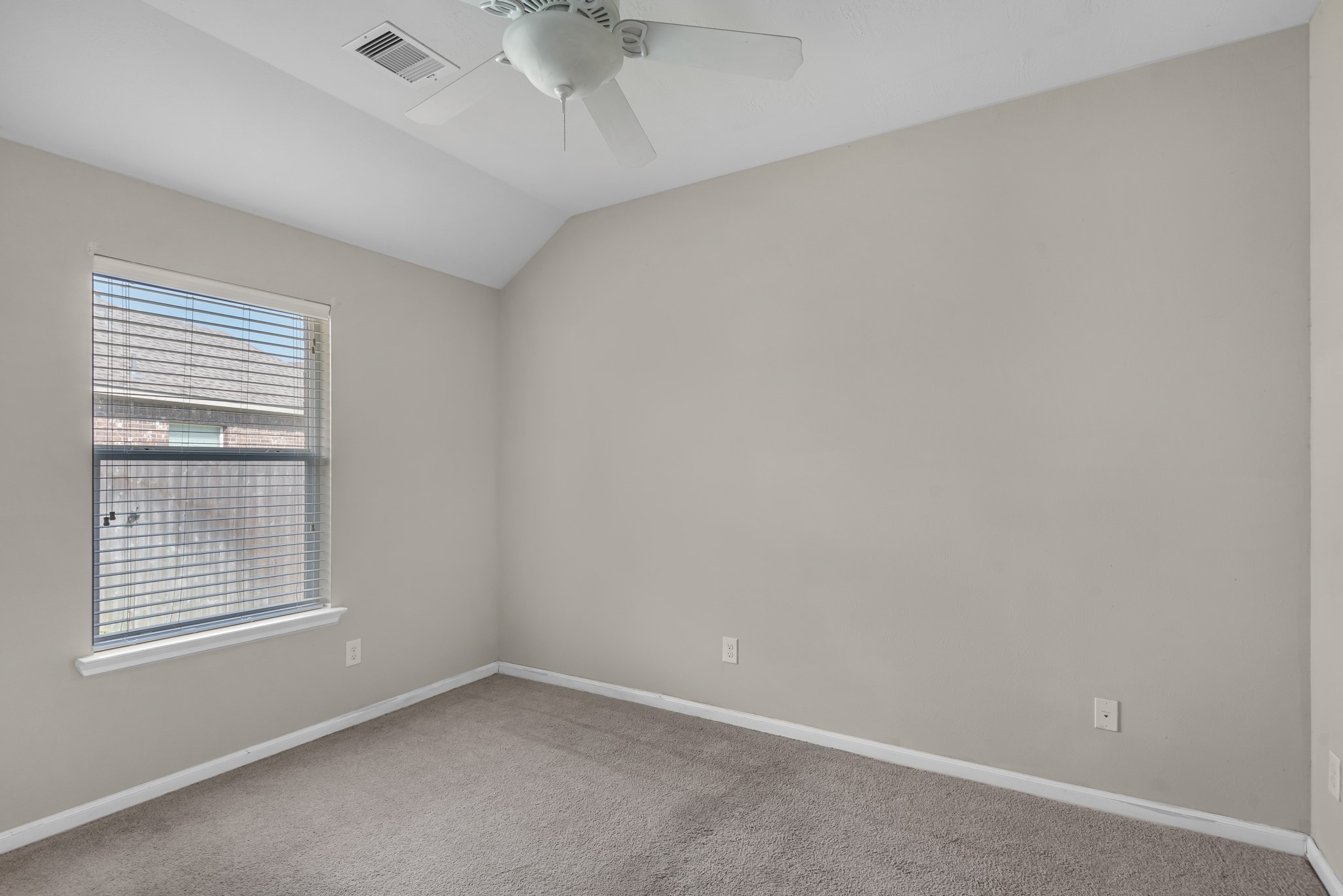 8514 Sweetstone Field Court Cypress, TX 77433 - Photo 17 of 23 an empty room with a window and ceiling fan