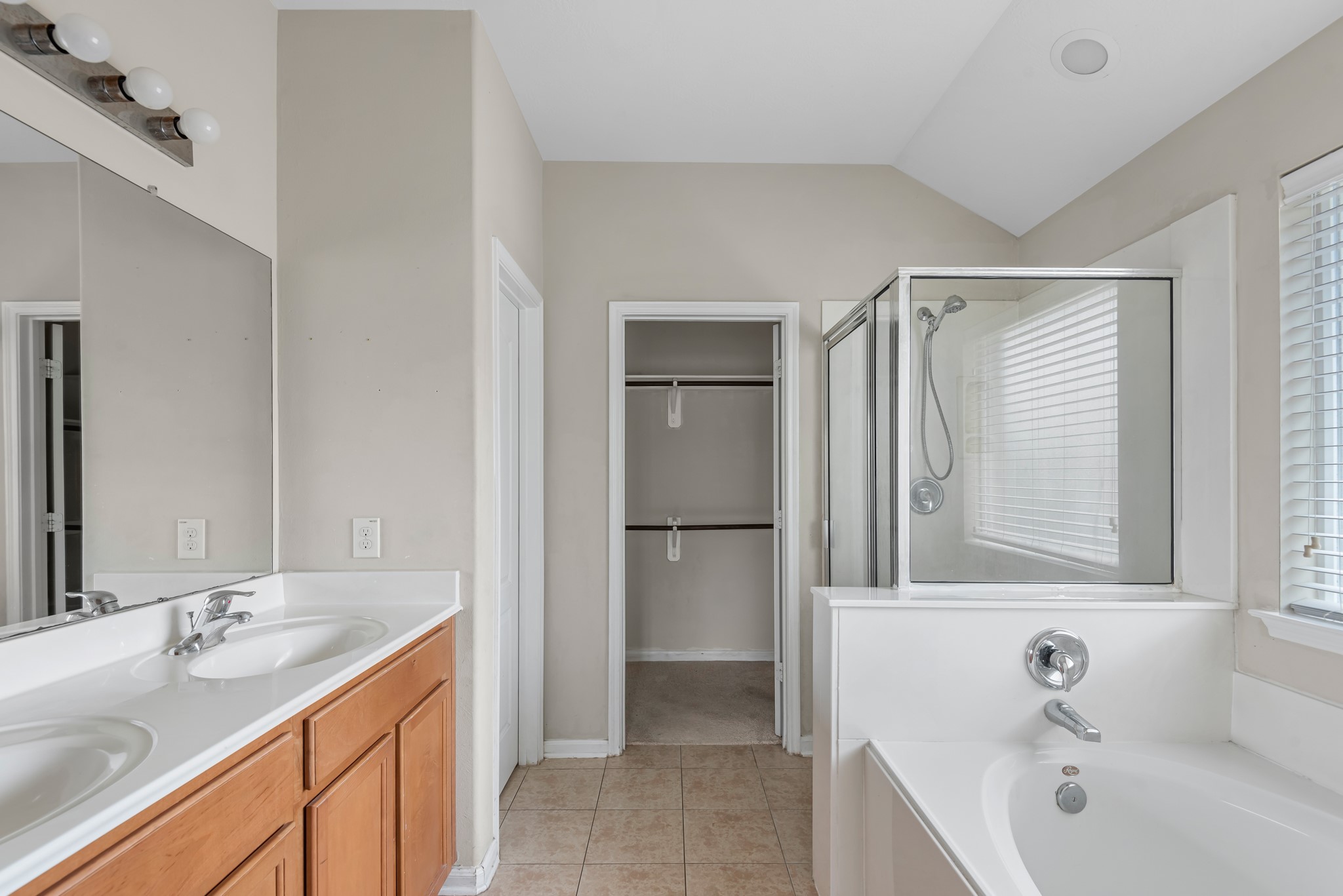 8514 Sweetstone Field Court Cypress, TX 77433 - Photo 20 of 23 a bathroom with a tub sink and mirror