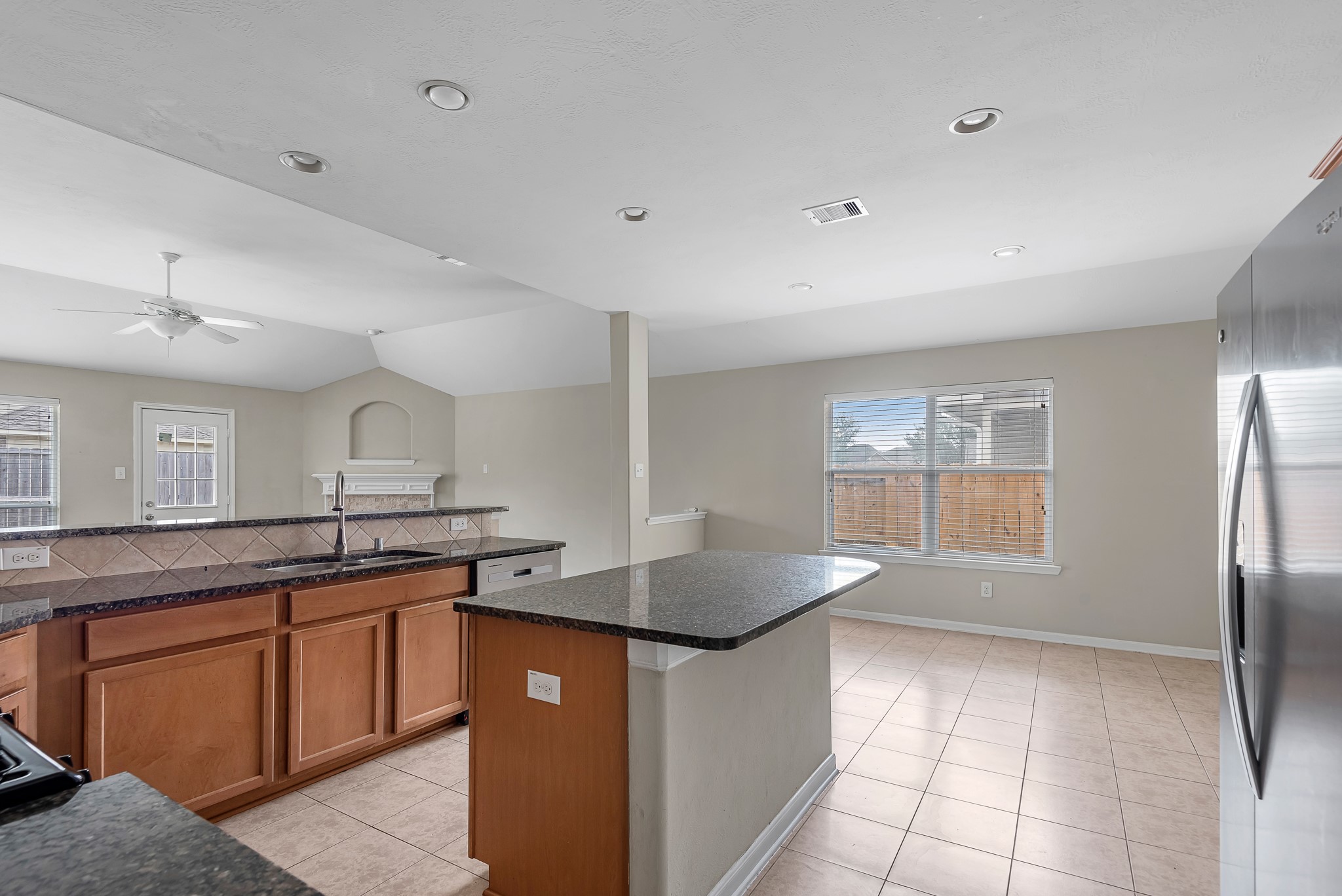 8514 Sweetstone Field Court Cypress, TX 77433 - Photo 5 of 23 a kitchen with granite countertop a sink a counter top space and stainless steel appliances