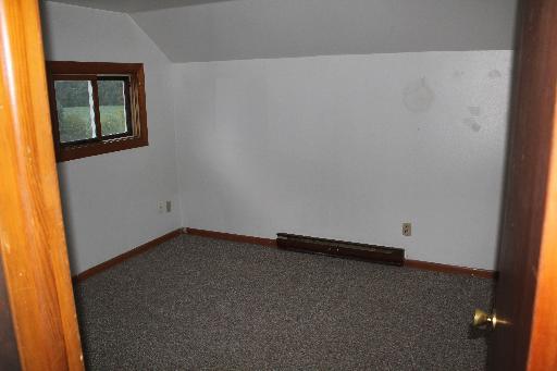 4762 East 2351st Road Somonauk, IL 60552 - Photo 6 of 8 an empty room with a door