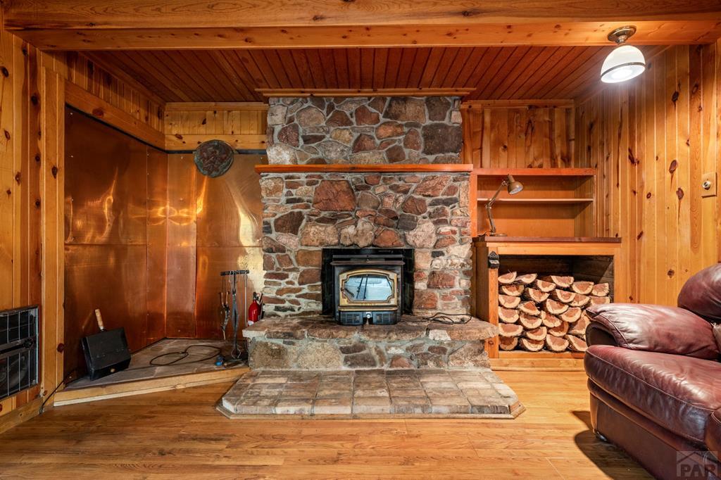 9600 Middle Creek Canyon Road Beulah, CO 81023 - Photo 11 of 50 a living room with furniture and a fireplace