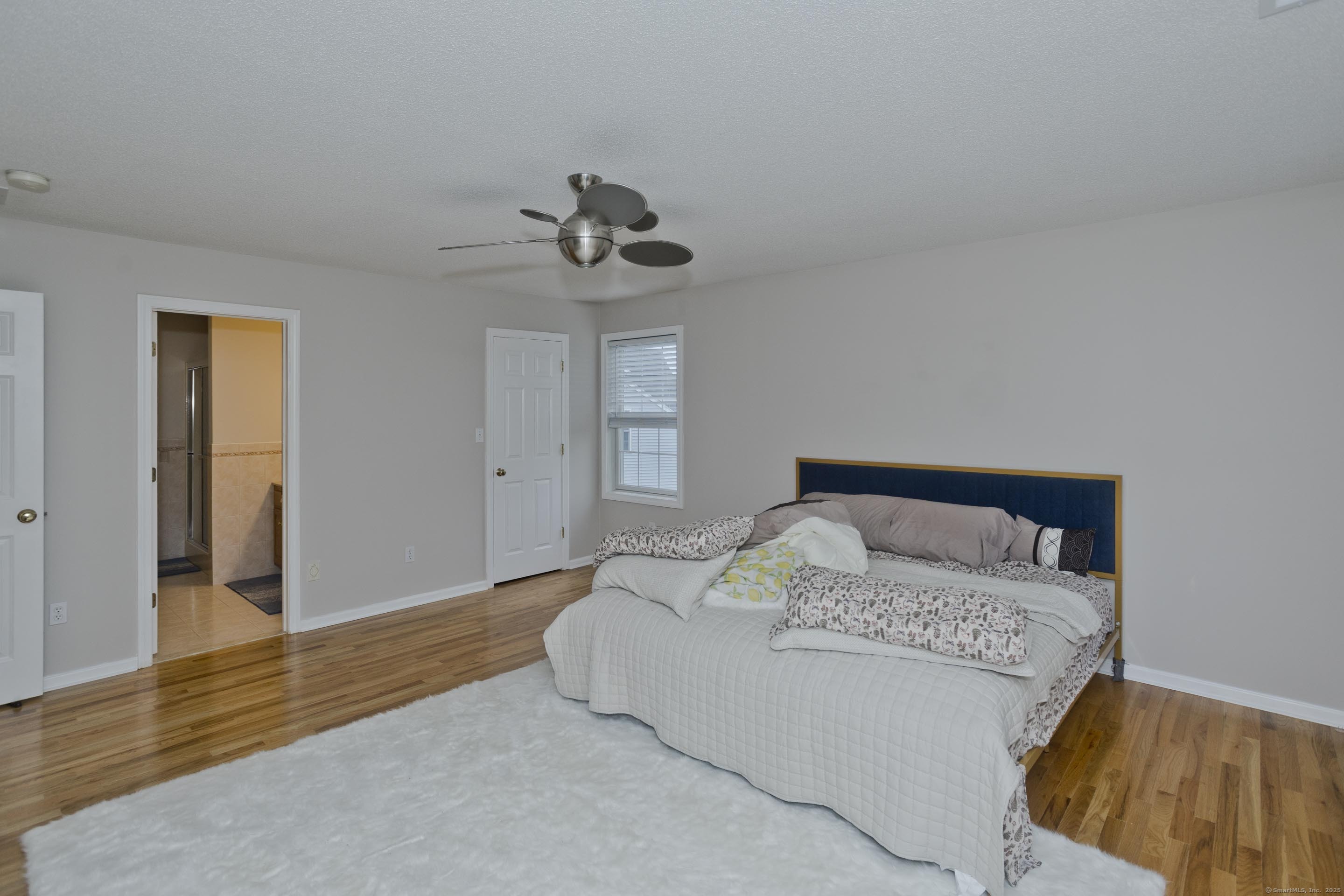 120 Scenic View Drive Middletown, CT 06457 - Photo 11 of 24 a bedroom with a large bed and wooden floor