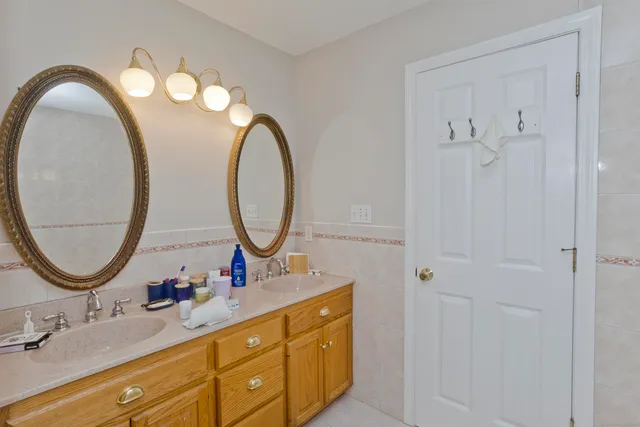 a bathroom with a double vanity sink and a mirror