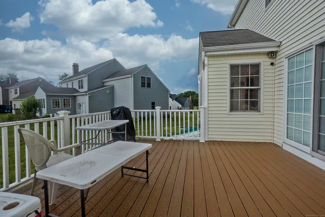 a view of a house with wooden deck
