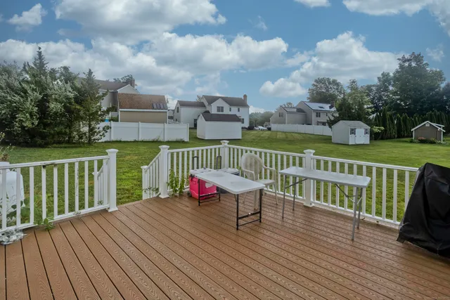 a view of roof deck with a table and chairs and wooden floor