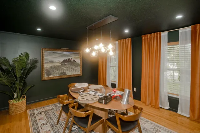 a dining room with furniture and wooden floor
