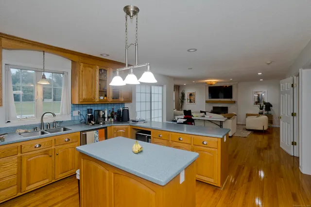 a kitchen with sink cabinets and living room