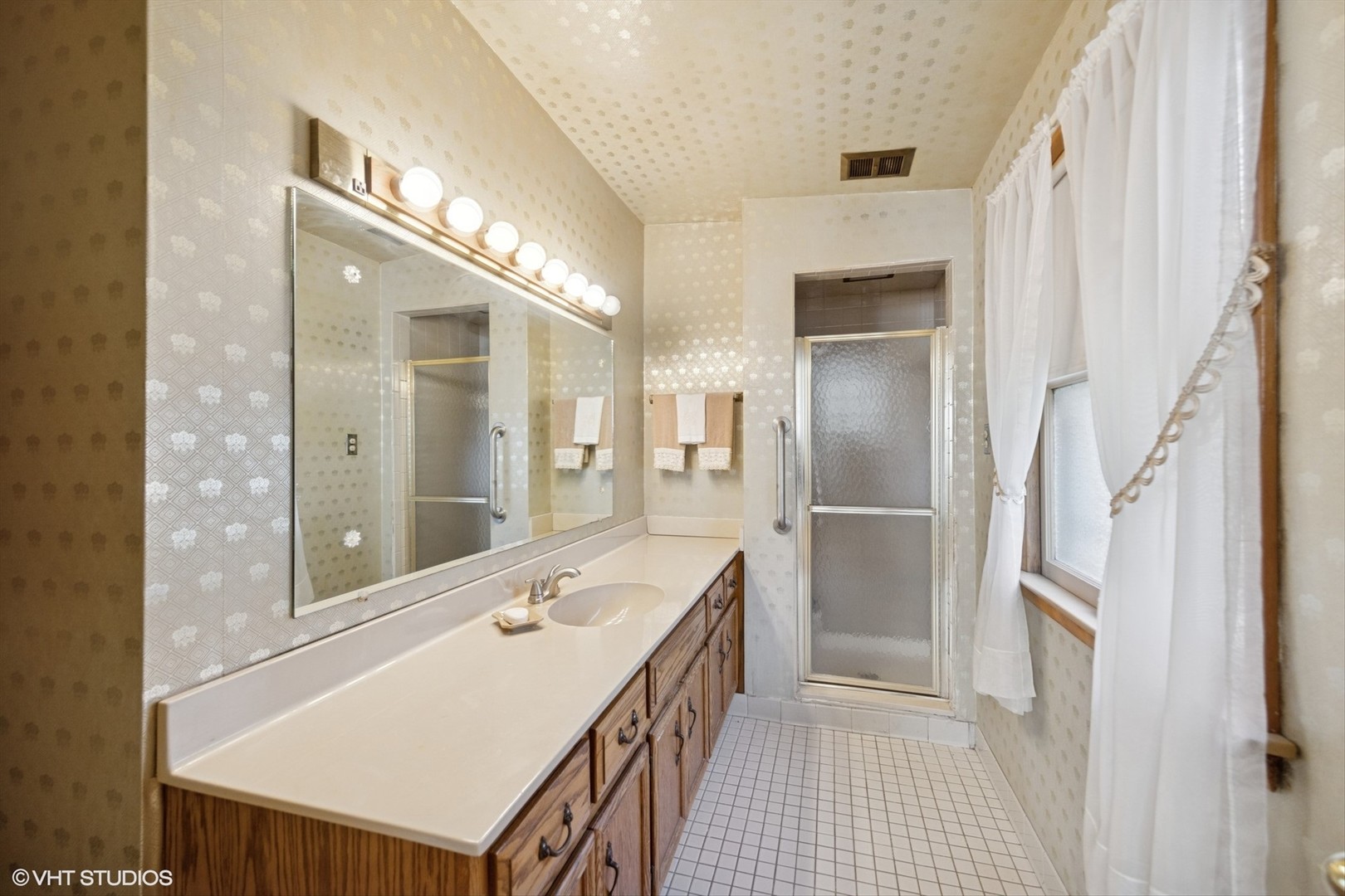 506 South Charleton Street Willow Springs, IL 60480 - Photo 12 of 21 a bathroom with a sink a large mirror and a shower
