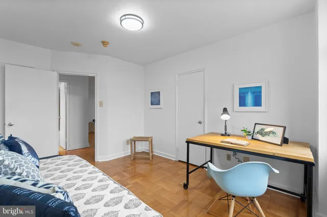 a bedroom with a bed a desk and chair