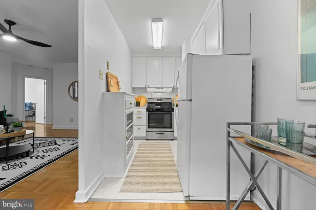 a kitchen with stainless steel appliances granite countertop a refrigerator and a stove