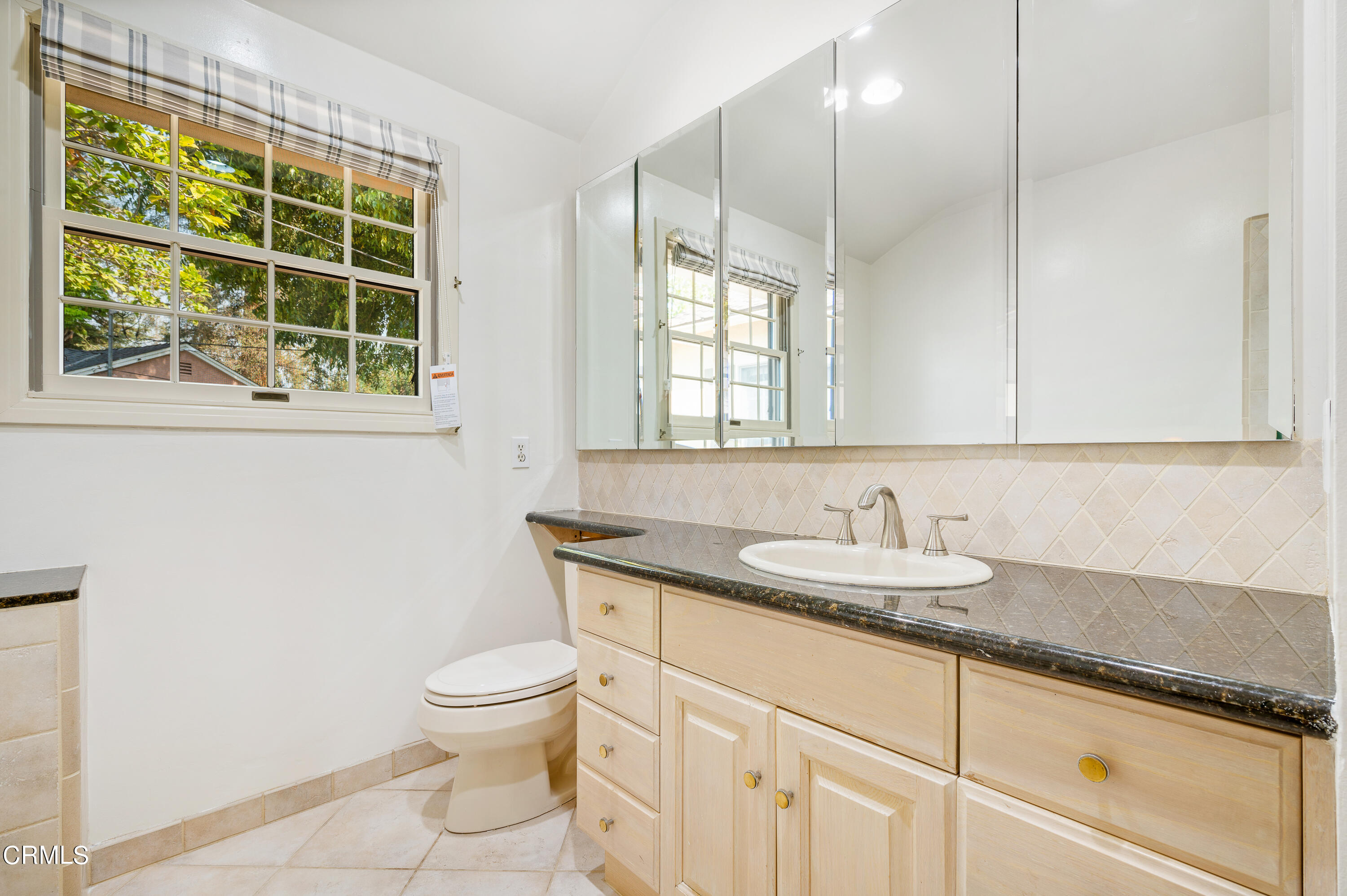 517 St Albans Road San Gabriel, CA 91775 - Photo 18 of 24 a bathroom with a granite countertop sink a toilet and a mirror