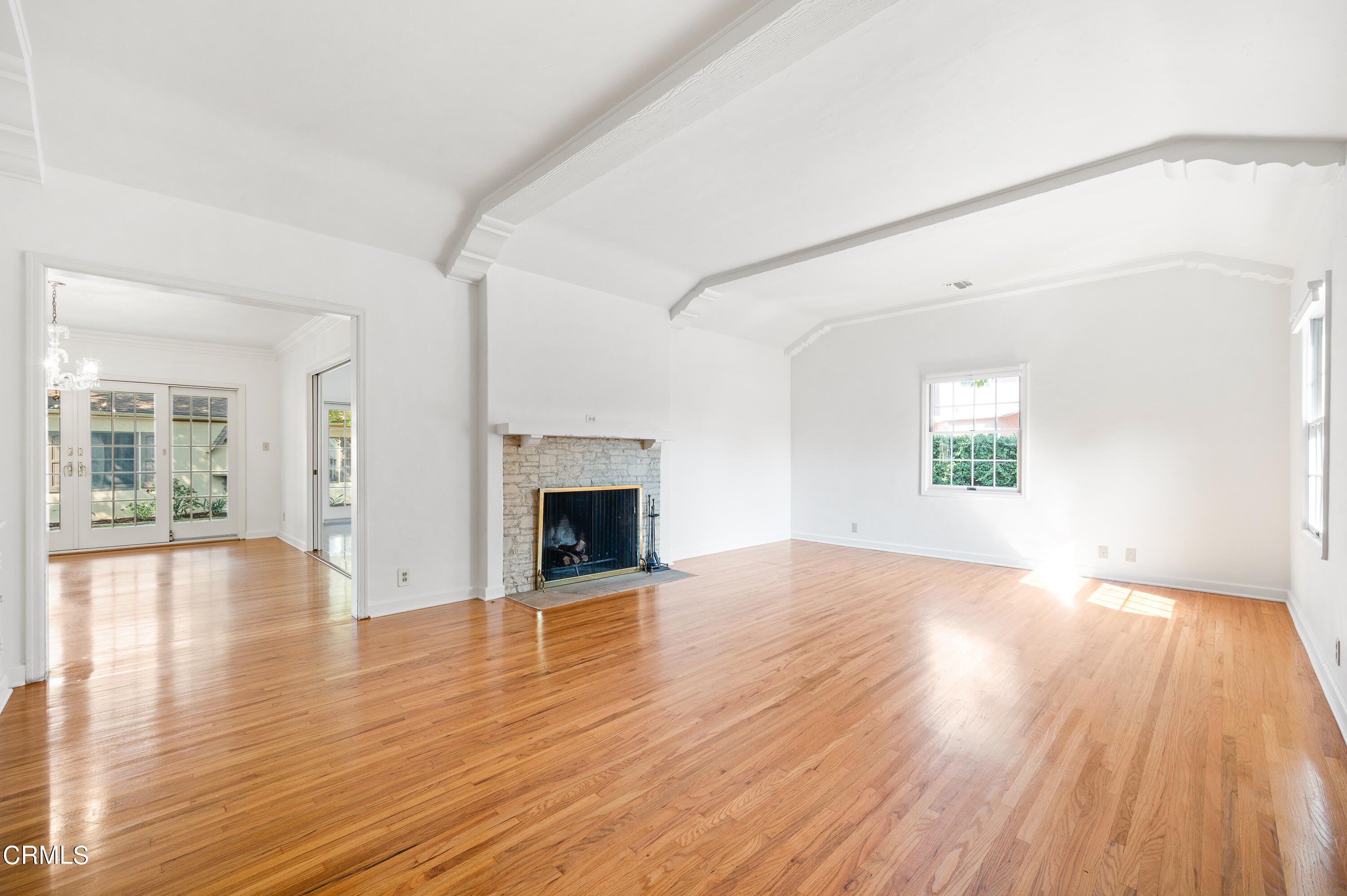 517 St Albans Road San Gabriel, CA 91775 - Photo 3 of 24 an empty room with wooden floor and fireplace