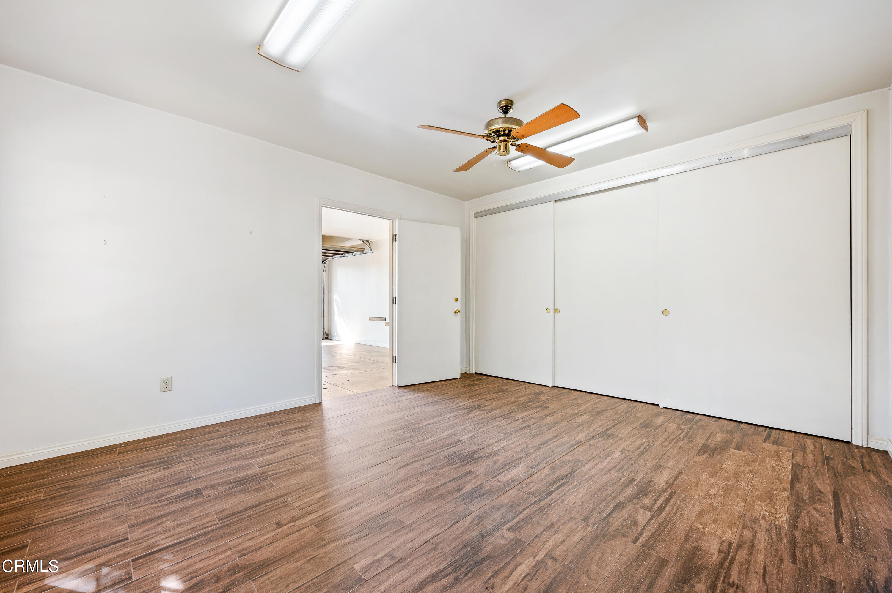 517 St Albans Road San Gabriel, CA 91775 - Photo 23 of 24 an empty room with wooden floor ceiling fan and windows