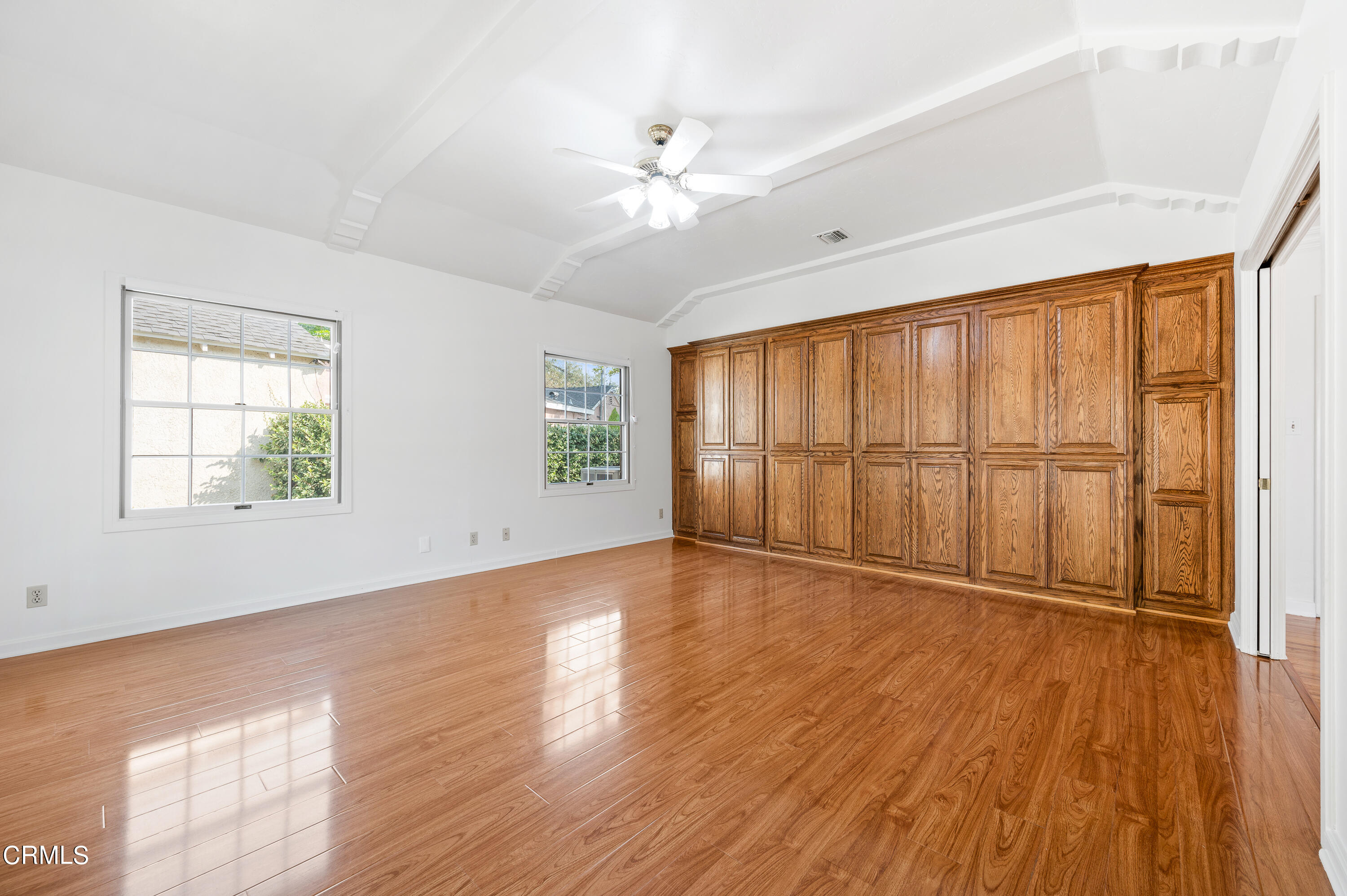 517 St Albans Road San Gabriel, CA 91775 - Photo 7 of 24 an empty room with wooden floor fan and windows