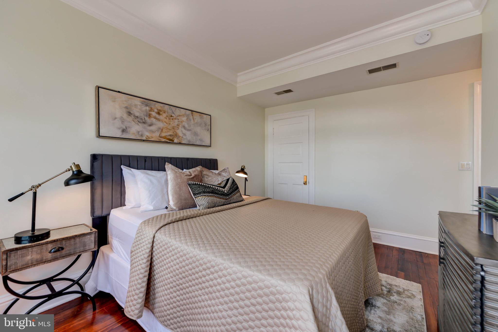 2130 Leroy Place Northwest Washington, DC 20008 - Photo 69 of 98 a bedroom with bed and paintings on the wall