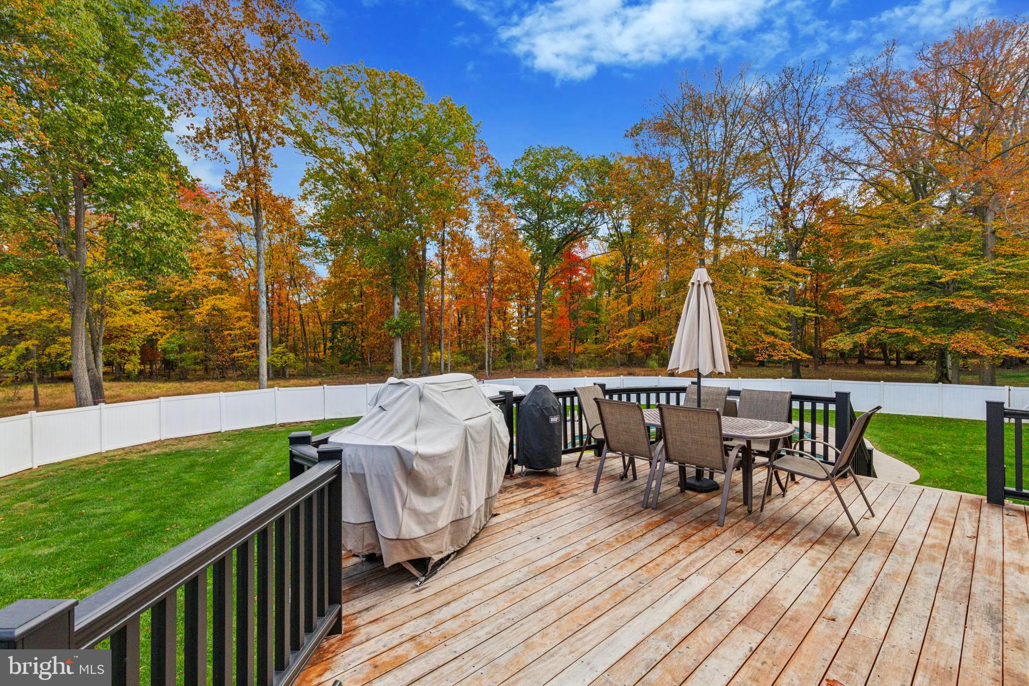 703 Daventry Way Ambler, PA 19002 - Photo 48 of 54 a view of a patio with table and chairs with wooden floor and fence