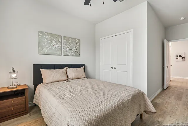 a bedroom with a bed and a night stand