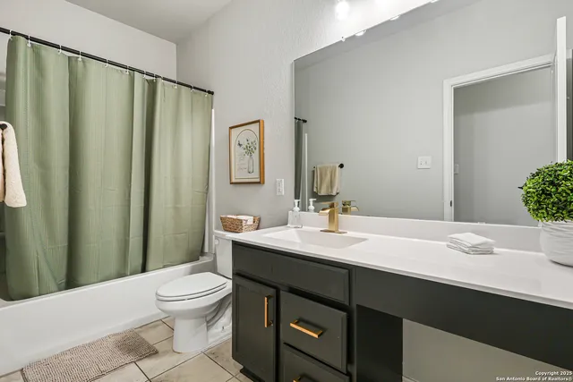 a bathroom with a sink a toilet and mirror