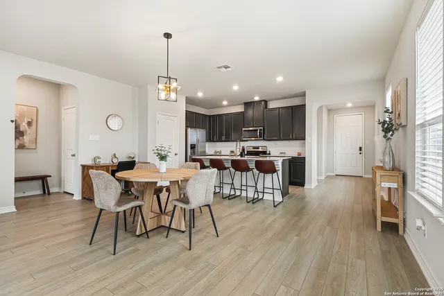 a view of a dining room with furniture window and wooden floor