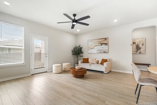 a living room with furniture and wooden floor