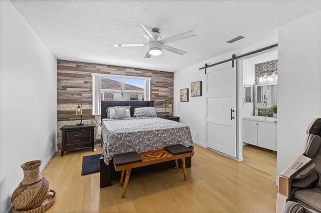a bedroom with a bed and wooden floor