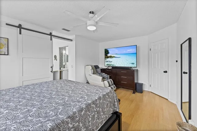 a bedroom with a bed dresser and a window