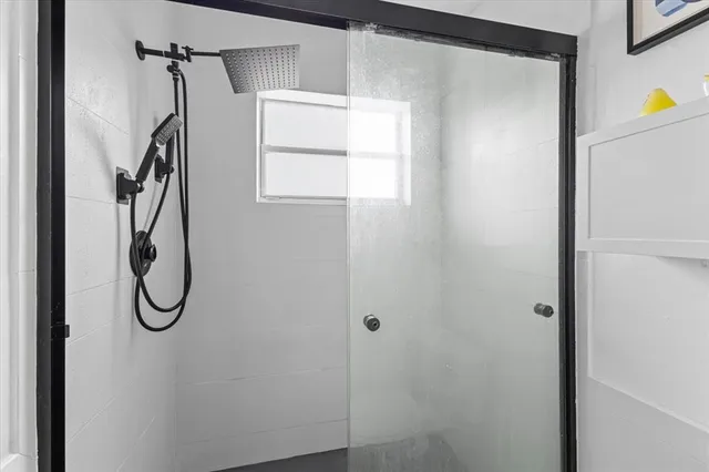 a bathroom with a glass shower door