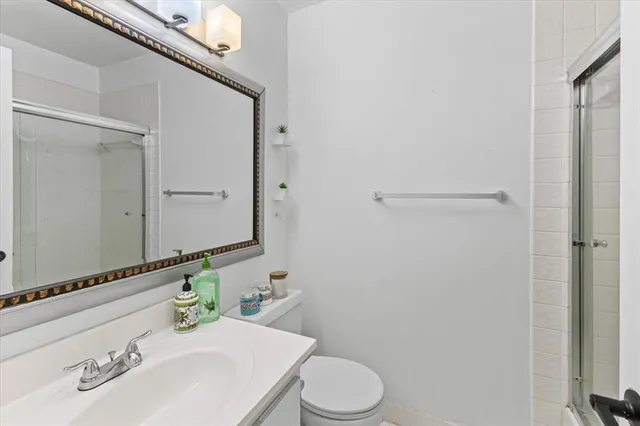 a bathroom with a sink a toilet and mirror