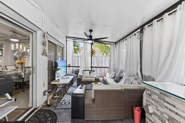 a living room with furniture and large windows