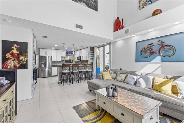 a living room with furniture and kitchen view